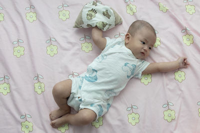 Cute baby lying on bed