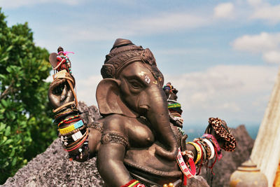 Low angle view of statue against sky