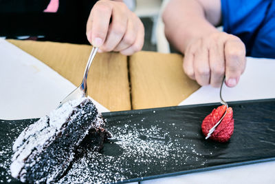 Close-up of man preparing food on table