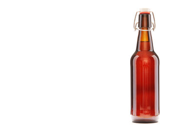 Corked beer bottle against white background