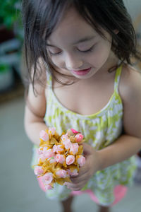 Close-up of girl holding flowering plant