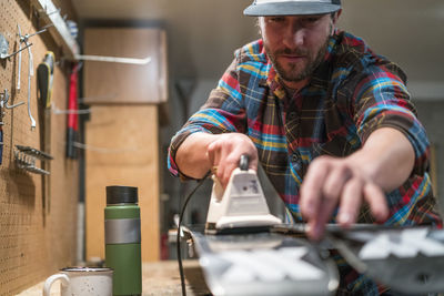 Man waxes his skis in a workshop in lake tahoe, ca