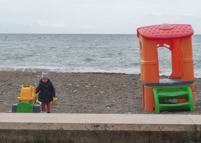 Full length of woman on sea shore against sky