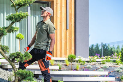 Side view of young man exercising on street