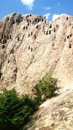 Low angle view of rock formations against sky