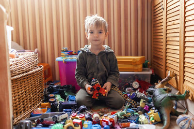 Portrait of boy playing with toys at home