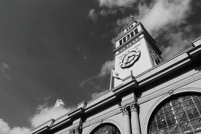 Low angle view of building against cloudy sky