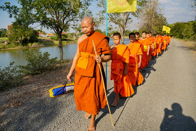 Panoramic view of people on road against trees