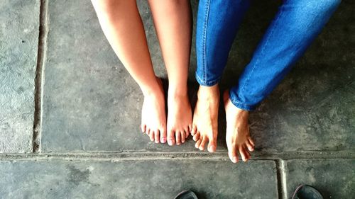 Low section of woman standing on tiled floor