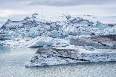 Scenic view of icebergs floating in jokulsarlon glacier lagoon against sky