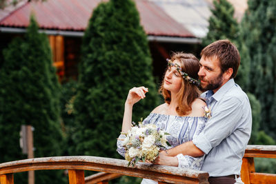 Couple kissing on flower against plants