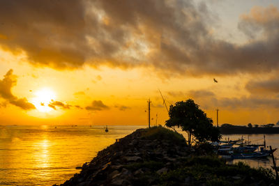 Tranquil dawn seascape. beautiful sunrise over the sea, featuring traditional fishing boats.