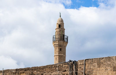 Low angle view of historical building against cloudy sky