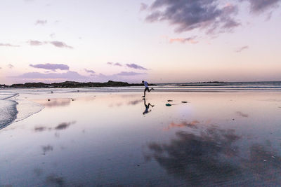 Scenic view of sea against sky at sunset