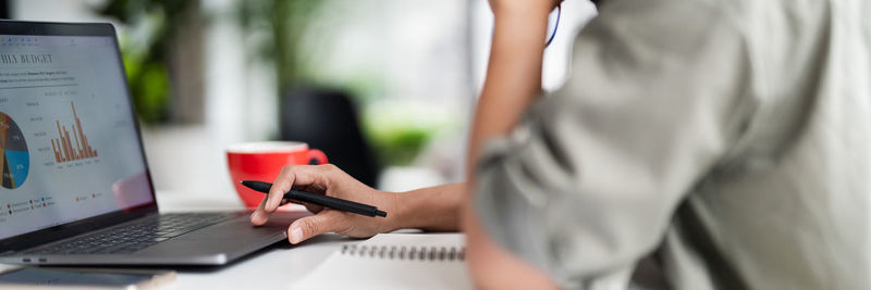 Midsection of man using laptop