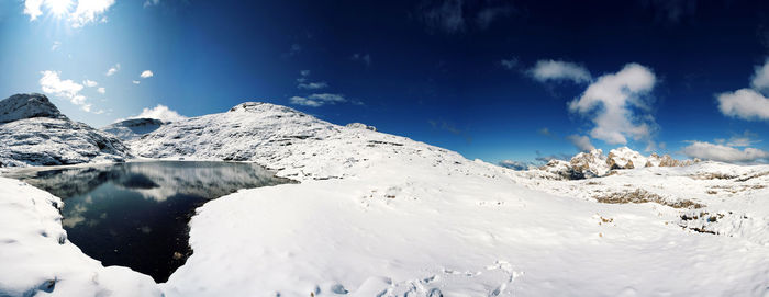 Scenic view of snow covered mountains against sky