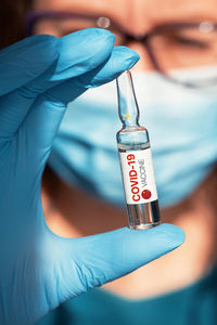 Close-up of human hand holding covid-19 vaccine