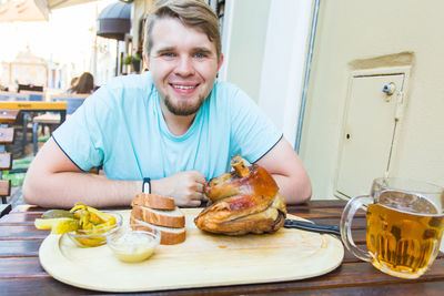 Portrait of man with food on table