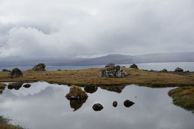 Scenic view of sea against cloudy sky