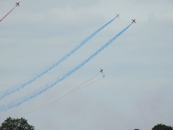 Low angle view of airplane flying against sky