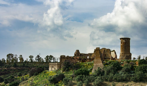 Old ruin building against cloudy sky