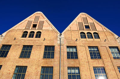 Low angle view of building against blue sky