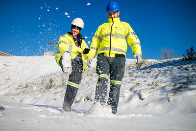 Young woman and man having fun on snow 