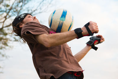 Man jumping to catch soccer ball