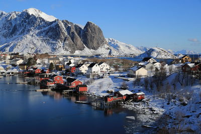 Panoramic view of buildings and mountains against sky during winter