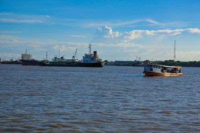 Ship sailing on sea against sky