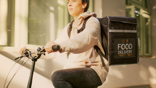 Side view of young woman using mobile phone