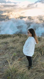 Side view of woman standing on field
