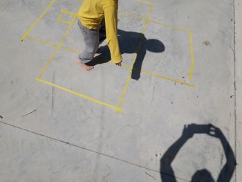 Low section of man standing on road