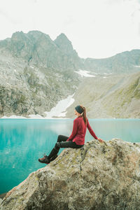 Woman on rock by mountains