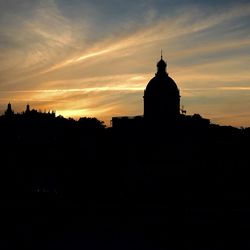 Silhouette of building against sky at sunset