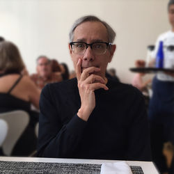 Portrait of senior man sitting at table in restaurant