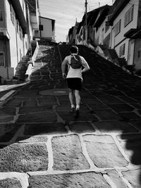 Rear view of man walking on steps