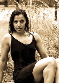 Portrait of young woman sitting outdoors