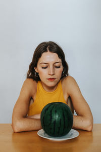 Young woman sitting on table