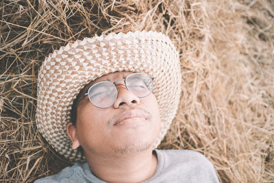 Close-up portrait of a young woman lying down