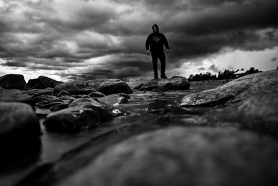 Rear view of man standing on rock