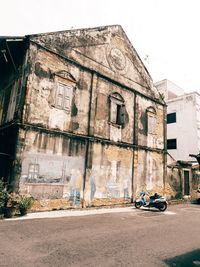 Graffiti on old building against sky