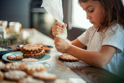 Midsection of woman having food at table