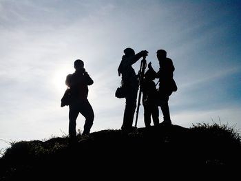 Low angle view of silhouette man standing against sky