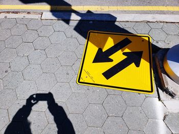 High angle view of arrow sign on street