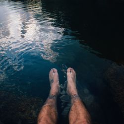 Low section of man relaxing in river
