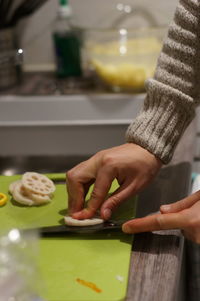 Close-up of woman preparing food on table