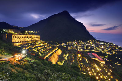 High angle view of illuminated buildings in city at night