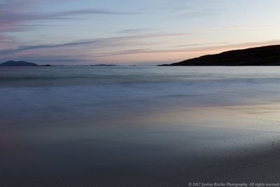 Scenic view of sea against sky at sunset