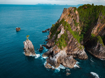 High angle view of rocks in sea against sky